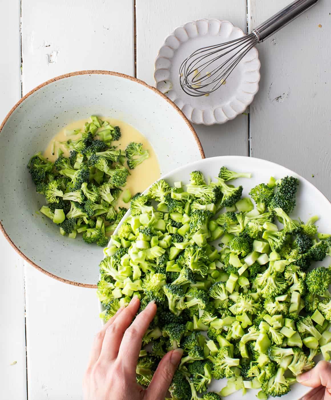 Adding florets to bowl of creamy dressing