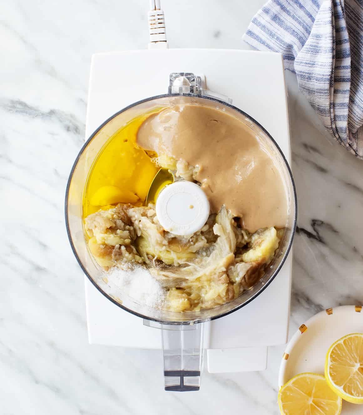 Eggplant, tahini, olive oil, garlic, and salt in a food processor