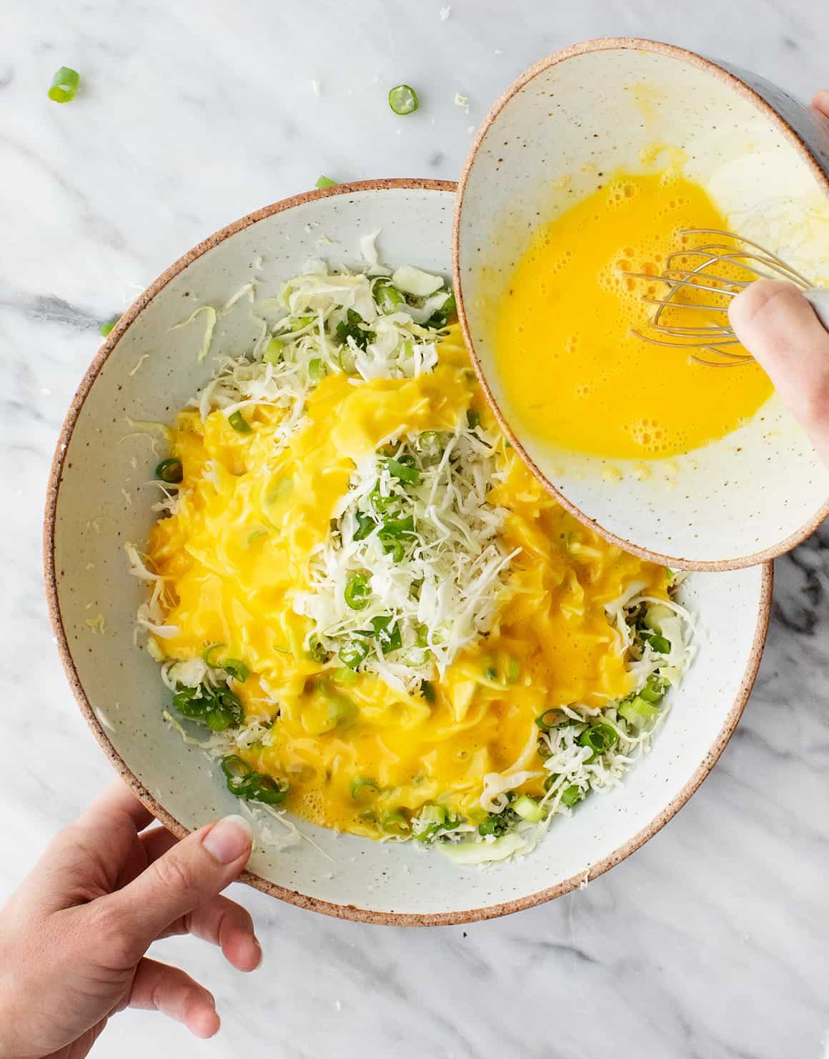 Egg, cabbage, and scallions in a bowl