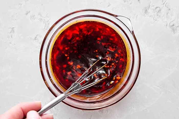 Make the dressing. In a small bowl, whisk together the sesame oil, tamari soy sauce, rice vinegar, honey, garlic, and chili oil.