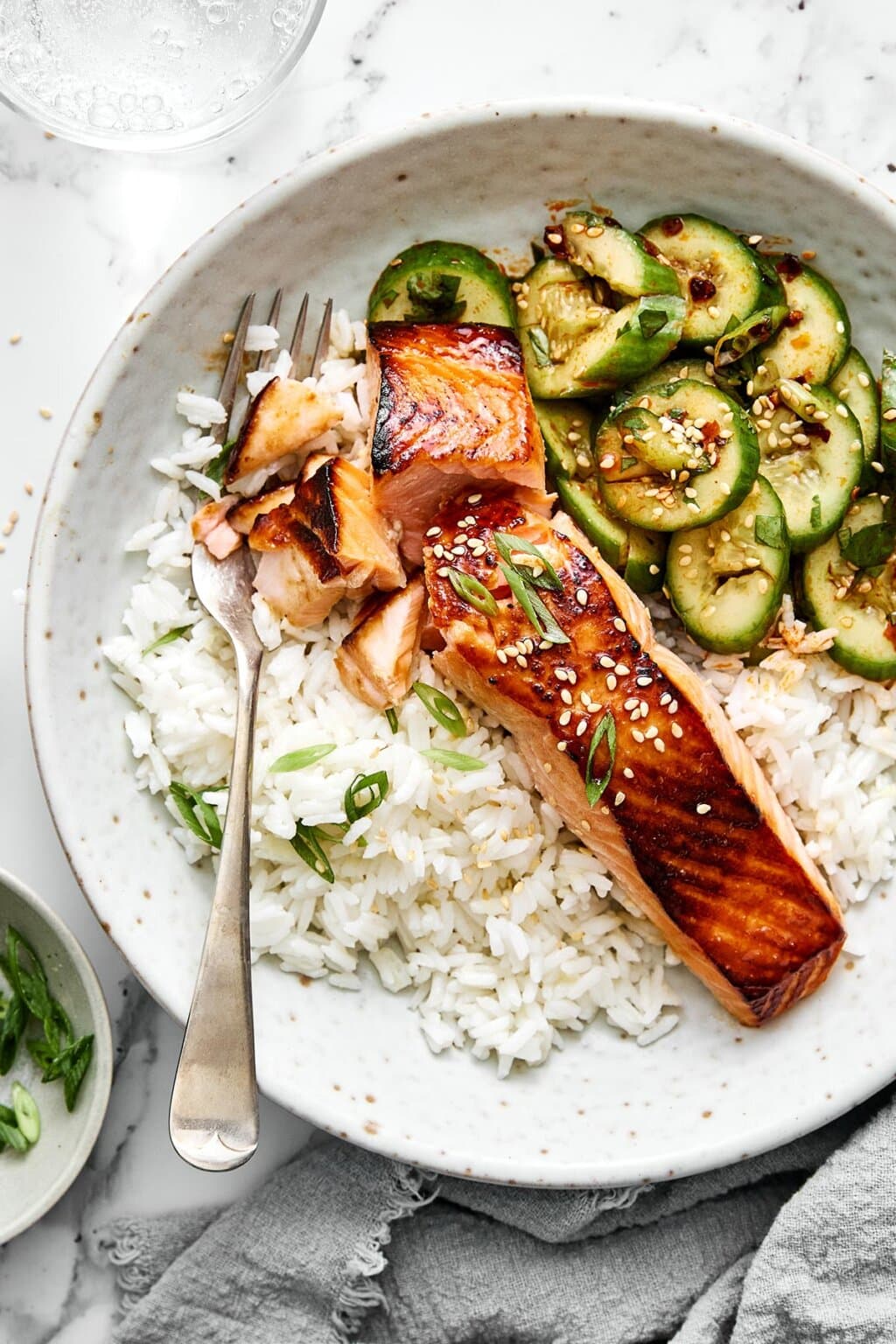 A bowl of ginger rice, miso salmon, and cucumber salad.