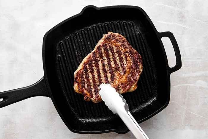 Grill the steak. Add the steak to the grill and close the lid. Grill for 3 to 4 minutes, then flip and cook for another 3 to 4 minutes or until the center reads 130°F (54°C) on an instant read thermometer, for medium-rare. Alternatively, you can pan sear the steak as well. Let the steak rest for 5 minutes, then thinly slice against the grain.