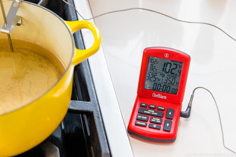 After 70–80 minutes, pour 4 cups safflower oil into a Dutch oven or heavy-bottomed pot (see Notes for how much oil to use). Set up a cooking thermometer, if you have one. Set the alarm to a low of 325ºF (168ºC) and a high of 350ºF (177ºC). Tip: I use ThermoWork’s ChefAlarm. A clip attaches the probe to the side of the Dutch oven, holding it securely in place.