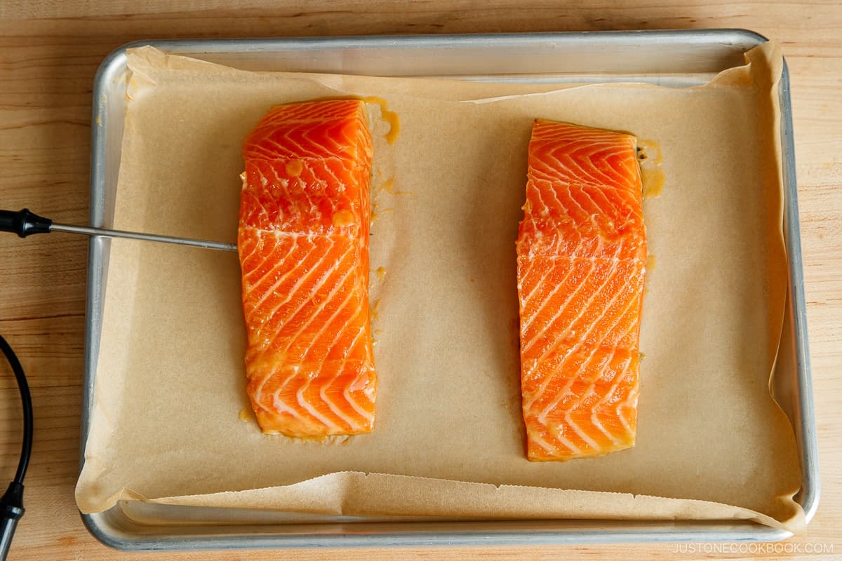Place the salmon skin side down on the prepared baking sheet. If using an oven probe, insert it into the thickest part of the fillet.Nami's Tip: If you don‘t have a probe, I highly recommend a Thermapen instant-read thermometer.