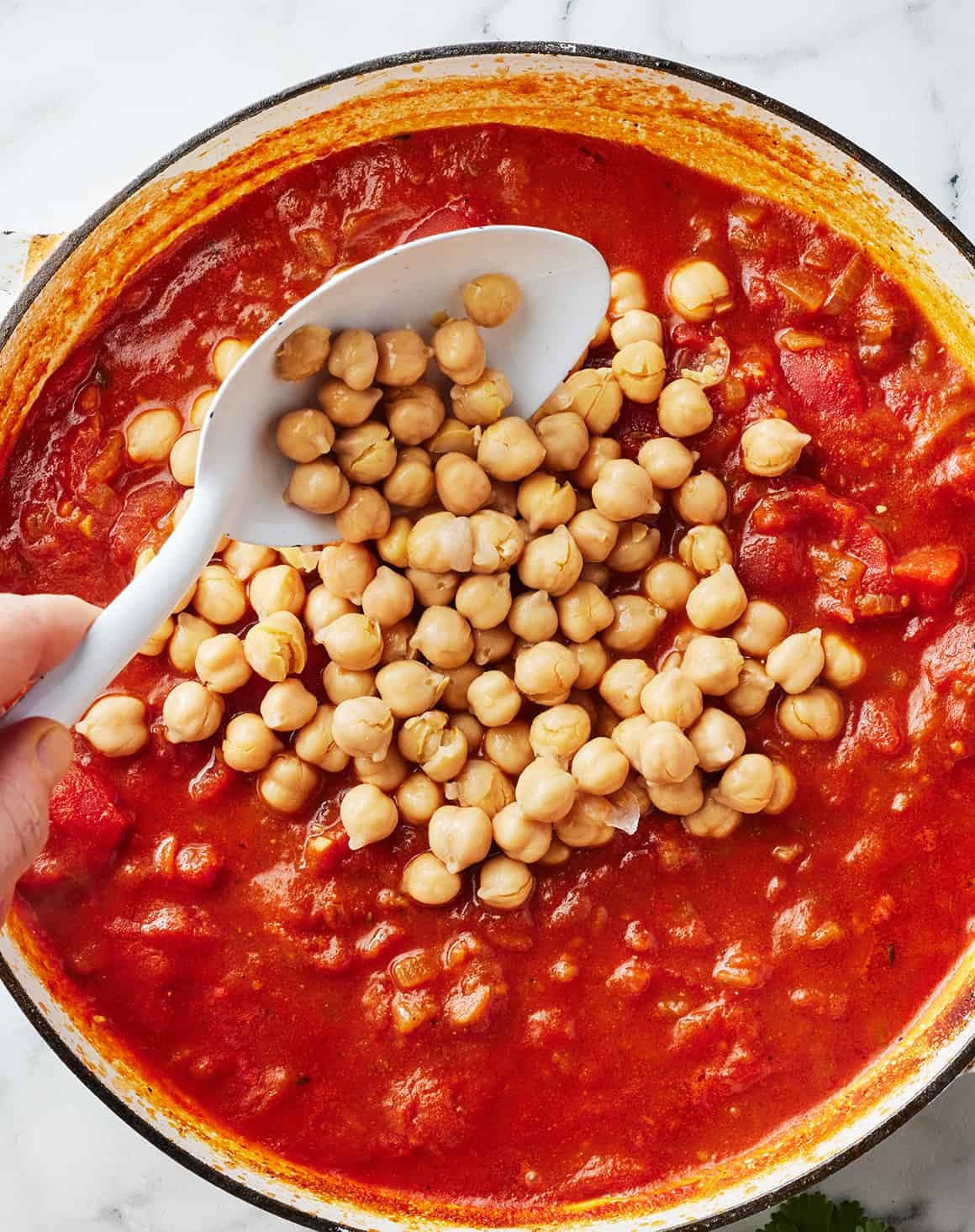 Adding chickpeas to tomato and onion sauce