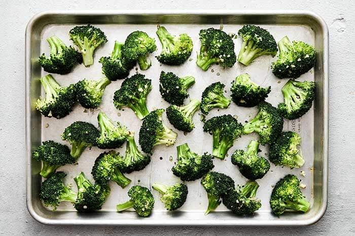 Season the broccoli. On a baking sheet, toss the broccoli florets in olive oil and minced garlic and season with salt and pepper. Spread them out into an even layer on the baking sheet.