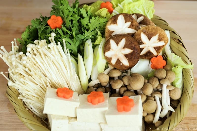 Arrange all the vegetables, mushrooms, and tofu on a serving platter.